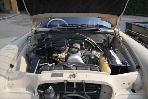 The engine and battery compartment of a classic car, with its detailed mech.. Stock Photos