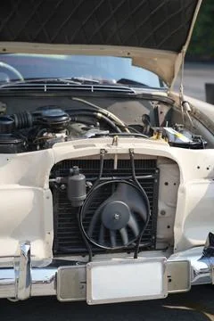 The engine and battery compartment of a classic car, with its detailed mech.. Stock Photos