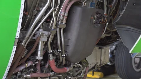 Engine and chassis of the passenger airplane under heavy maintenance. Engineer Stock Footage 84458850