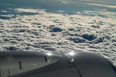 Engine and wing of aircraft on background of cloud Stock Photos
