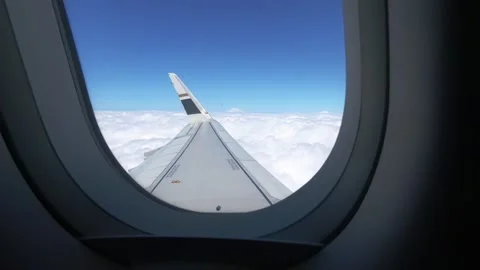An engine and wing seen from a window during a smooth stratospheric flight. Stock Footage 345353803