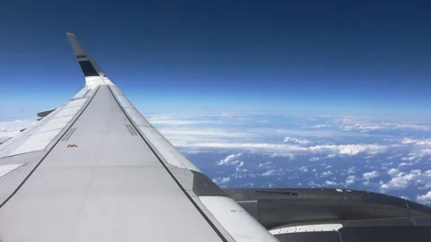 An engine and wing seen from a window during a smooth stratospheric flight. Stock Footage 345354874