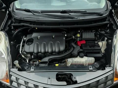 Engine bay of a modern compact car showcasing intricate machinery and compo.. Stock Photos