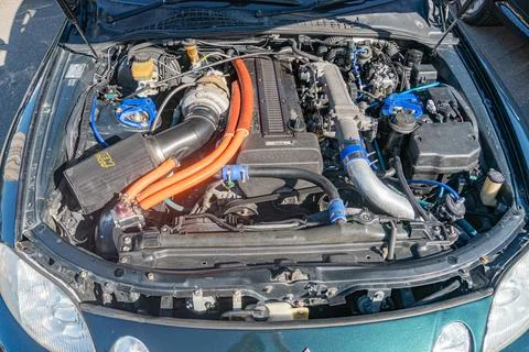 Engine bay view of a mid-sized vehicle, metallic components interconnected by Stock Photos
