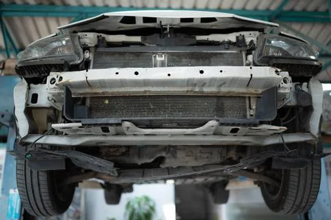 The engine of a car that has been hit hard. Professional technicians repai... Stock Photos