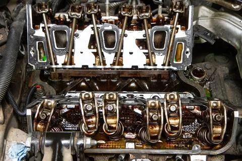 The engine of a car is open and the valves are visible Stock Photos