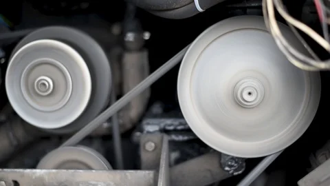 The engine of the car, in a running car, the movement of the belt pulley compres Stock Footage 110827247