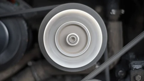 The engine of the car, in a running car, the movement of the belt pulley compres Stock Footage 110827250