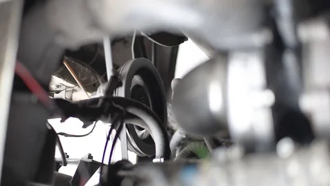 The engine of the car, in a running car, the movement of the belt pulley compres Stock Footage 110827317