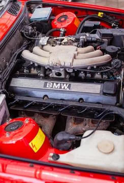The engine compartment of a BMW e30 with an installed motor M20B20 Stock Photos