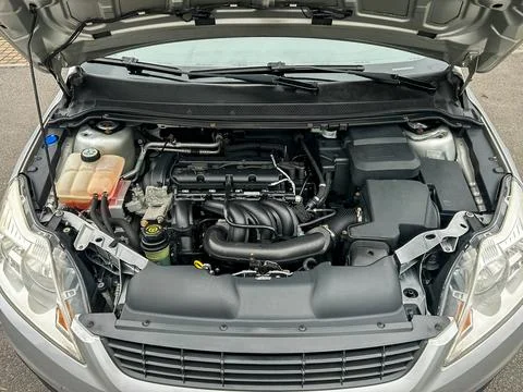 Engine compartment of a car showing various components and parts in a well-.. Stock Photos