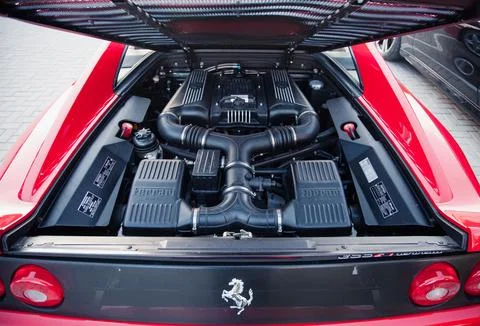Engine compartment of Ferrari 355F Berlinetta showing V8 and prancing horse.. Stock Photos