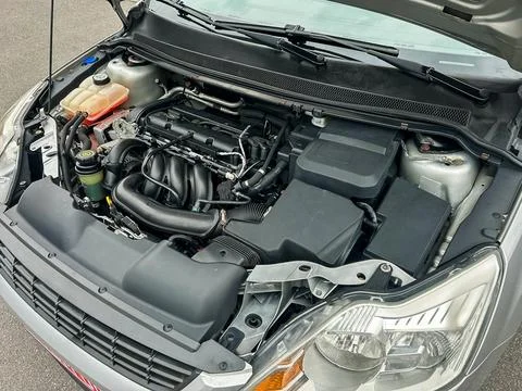 The engine compartment shows different parts including the engine block, hose 写真素材
