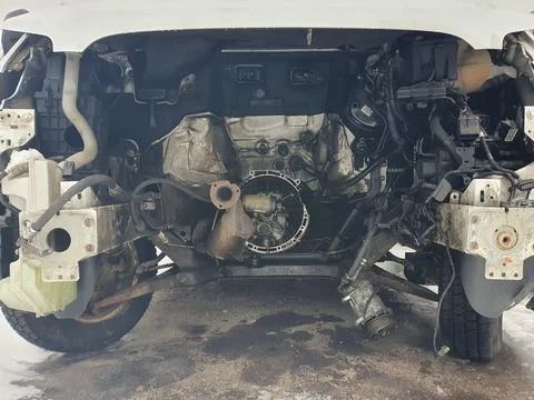 Engine compartment of a van car without an motor. Open hood with old cars det Stock Photos