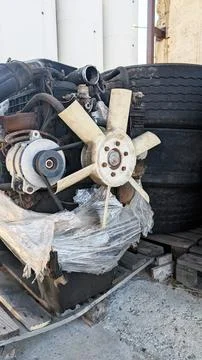 Engine cooling fan assembly with attached components, resting on wooden 写真素材