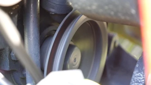 Engine drive train belt spinning with sound Stock Footage 107061074