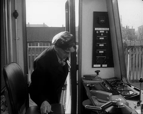 Engine driver coming into train driving cabin, UK 1957 Stock Footage 132323636