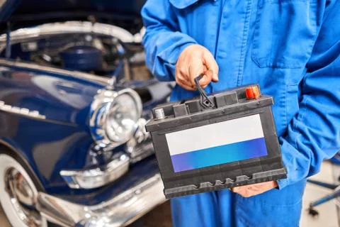 Engine engineer is replacing car battery because car battery is depleted Stock Photos