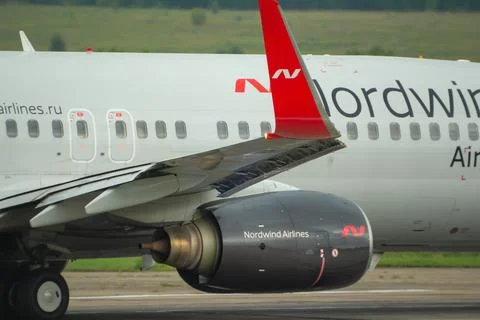 Engine, fuselage and wing of the Nordwind Airlines aircraft Stock Photos