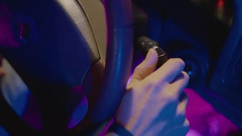Engine ignites as driver accelerates into glowing nighttime streets, Bright neon Stock Footage 330956413
