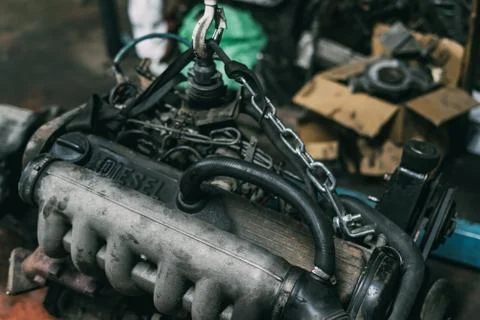 Engine instalation on crane hook on car repair service Stock Photos