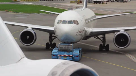 Engine intake close up with airplane on pushback in the background Stock Footage 45998582
