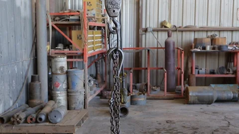 Engine lift or hoist in machine shop or mechanics Stock Footage 125833473