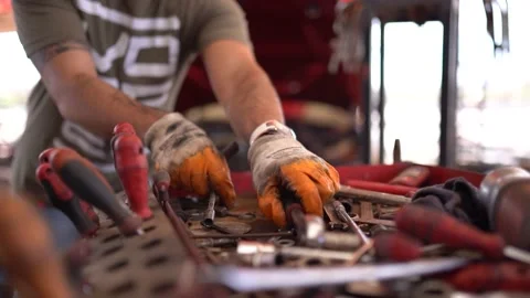 Engine master takes the equipment he uses from the bench Stock Footage 180892136