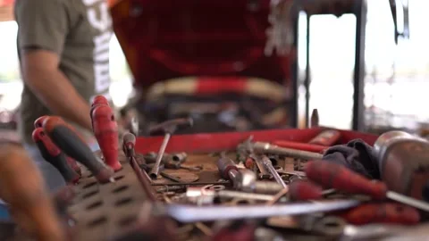 The engine mechanic throws the equipment he uses onto the tool bench Stock Footage 180888316