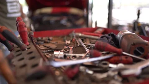 The engine mechanic throws the equipment he uses onto the tool bench Stock Footage 180894679