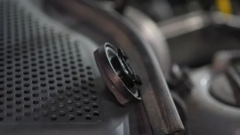 An engine oil filler cap rests upside down on plastic trim. Stock Footage 345708883