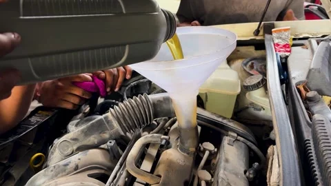 Engine Oil Filling Through Funnel During Professional Car Maintenance Service Stock Footage 339476641