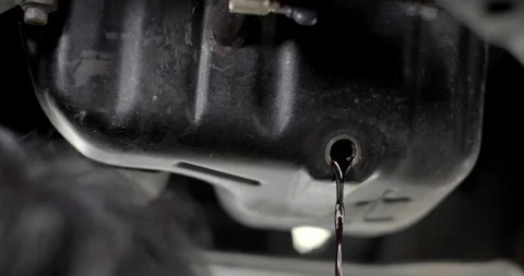 Engine oil is leaking out of the drain hole.Vehicle oil  drain hole. Stock Footage 311370256