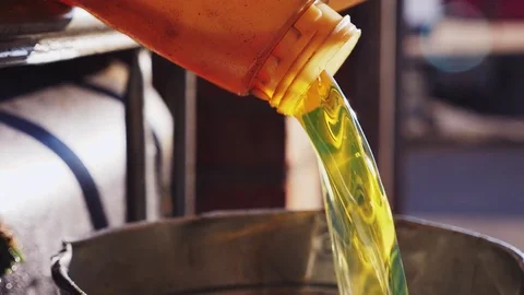 Engine oil poured into a metal bucket Stock Footage