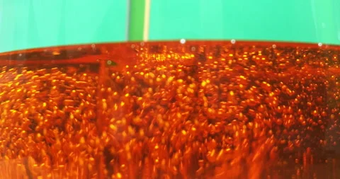 Engine oil pouring into a transparent container filled with tiny bubbles. 動画素材 229822048
