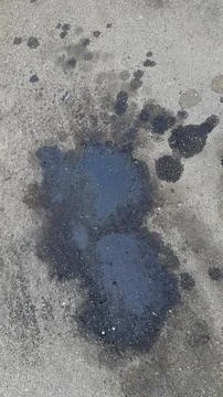 Engine oil puddle. Old plaster. Texture of old plaster wall. Vintage background Stock Photos