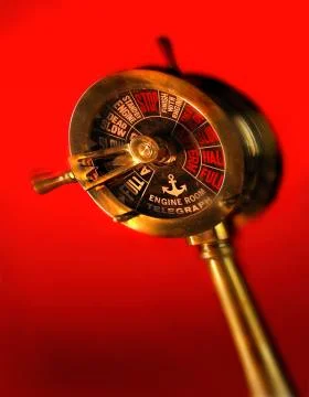 ENGINE ORDER TELEGRAPH AGAINST RED BACKGROUND Stock Photos
