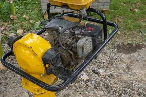 Engine part of  yellow jumping jack compactor Stock Photos
