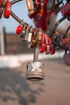 Engine piston among the wedding locks. The original idea of a wedding padlock Stock Photos