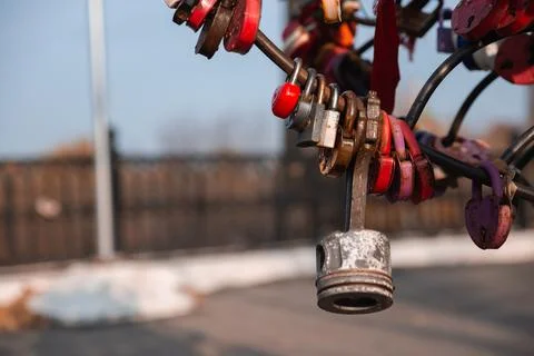 Engine piston among the wedding locks. The original idea of a wedding padlock Stock Photos