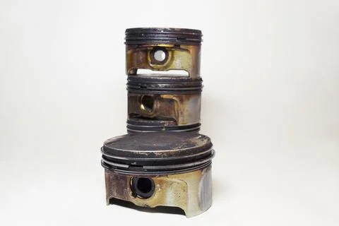 Engine piston in black sludge and burnt oil, with removed oil control ring,.. 库存照片