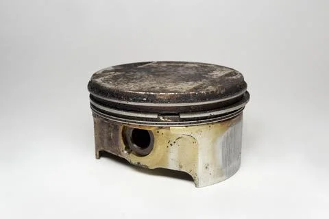 Engine piston with black sludge of deposit formations on flat head surface... Stock Photos