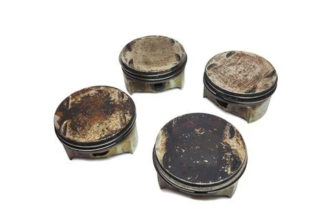 Engine pistons set of four. worn out change part of old car motor. surfaces.. Stock Photos