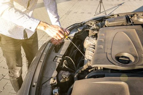 Engine problem. Driver man near open hood vehicle broken down on road. Auto m Stock Photos