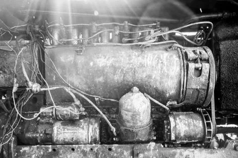 Engine of retro tractor, sunlight is scattered from above, monochrome effect Fotos Stock