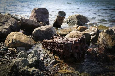 Engine rusting on a rocky beach, Environment and pollution Stock Photos