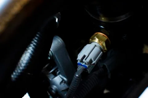 Engine sensor an installed on a car engine. Stock Photos
