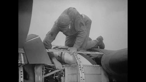 Engine specialist checks the mount and welded joints of the aircraft - 1942 Stock Footage 107698749