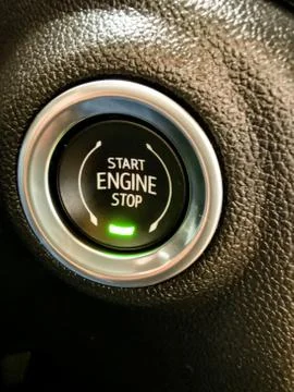 Engine start and off shining button of a luxury vehicle Stock Photos