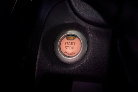 Engine start button of car with a orange light. Stock-Fotos